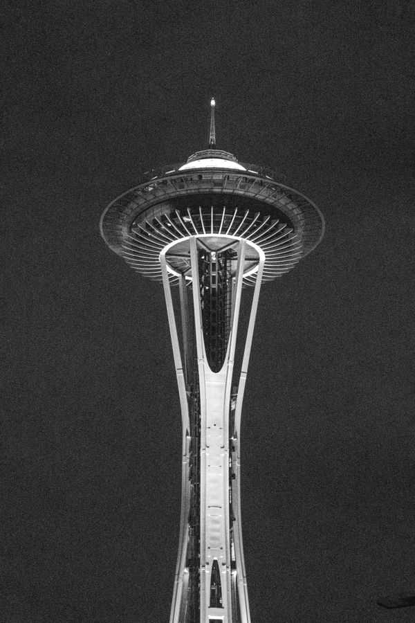 Black and white photo of the Space Needle against a flat grey sky